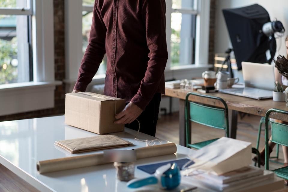 A small seller packing a parcel