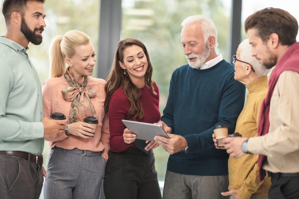 A group reviewing survey results on a tablet